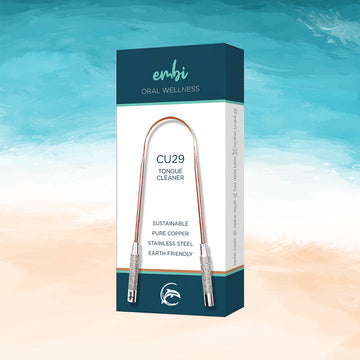 embi CU29 copper tongue cleaner packaging on beach background for fresh breath and oral hygiene