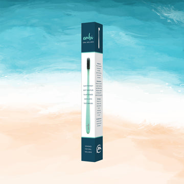 embi soft bristle toothbrush on a beach theme 